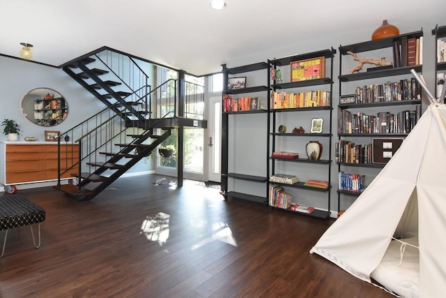interior space with floor to ceiling windows and wood finished floors
