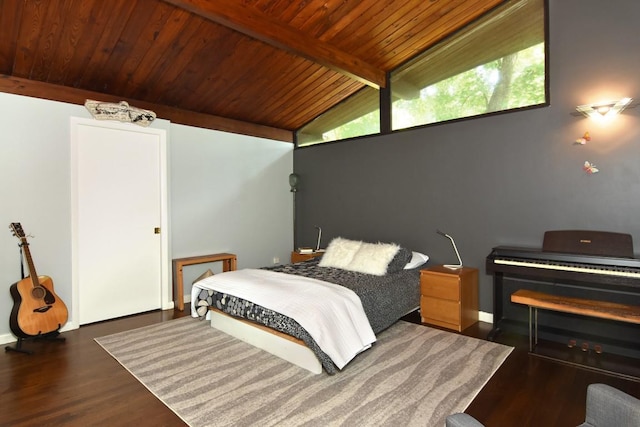 bedroom featuring lofted ceiling with beams, wood ceiling, and wood finished floors
