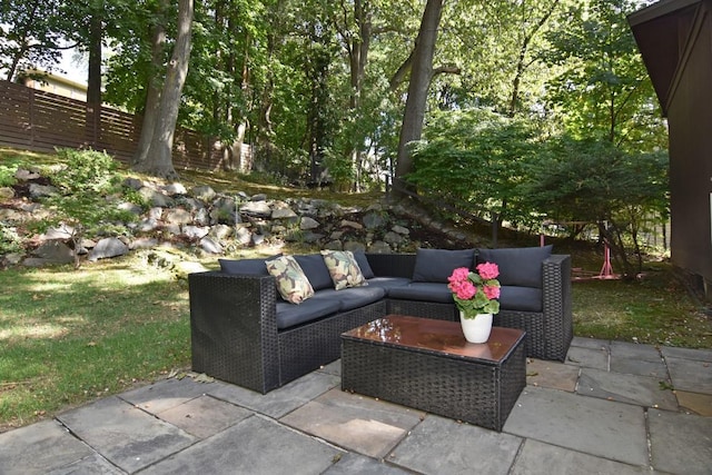 view of patio featuring an outdoor hangout area and fence