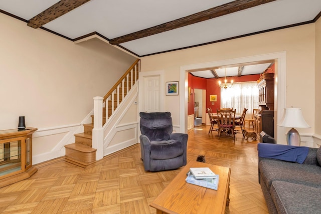 living area with a decorative wall, stairs, wainscoting, a chandelier, and beamed ceiling