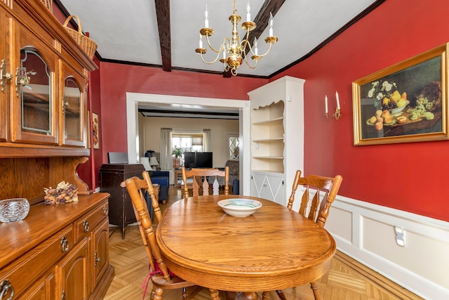 dining room featuring a wainscoted wall and a chandelier