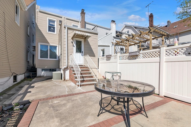 view of patio with central AC unit, fence, entry steps, and a pergola