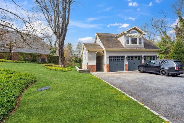 99 Wheatley Rd, Old Westbury, NY 11568 - view of home's exterior with aphalt driveway, a yard, and a garage