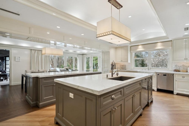 99 Wheatley Rd, Old Westbury, NY 11568 - kitchen featuring stainless steel dishwasher, a sink, a center island with sink, light wood-style flooring, and visible vents