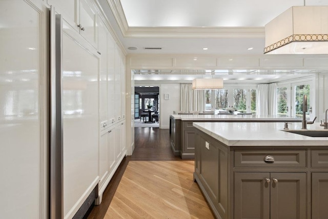 99 Wheatley Rd, Old Westbury, NY 11568 - kitchen with a sink, light wood-type flooring, visible vents, gray cabinets, and paneled built in fridge