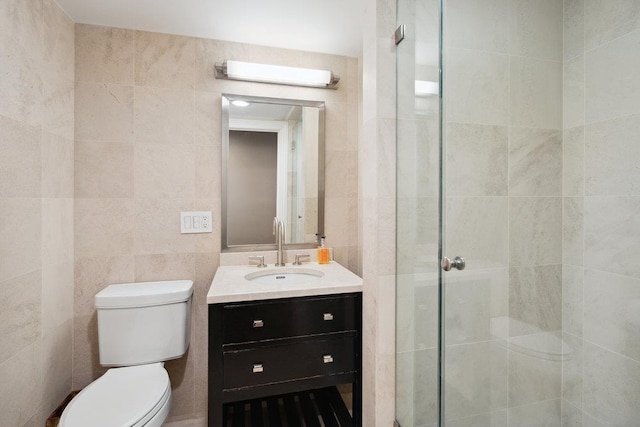 99 Wheatley Rd, Old Westbury, NY 11568 - full bathroom featuring tile walls, vanity, toilet, and a stall shower