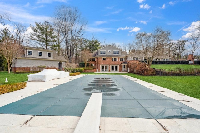 99 Wheatley Rd, Old Westbury, NY 11568 - exterior space with a lawn, a covered pool, fence, and a diving board