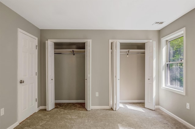 74 Foltim Way, Congers, NY 10920 - unfurnished bedroom with light colored carpet, baseboards, multiple closets, and visible vents
