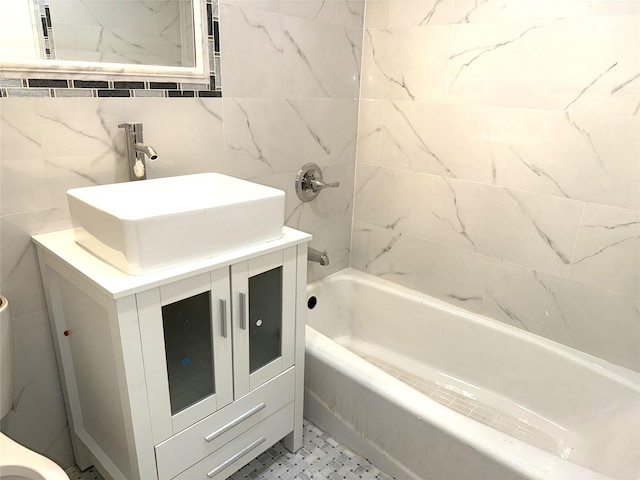 full bathroom with shower / bathtub combination, tile walls, and vanity