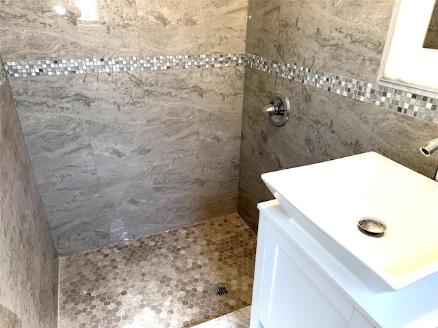bathroom with a sink and tiled shower