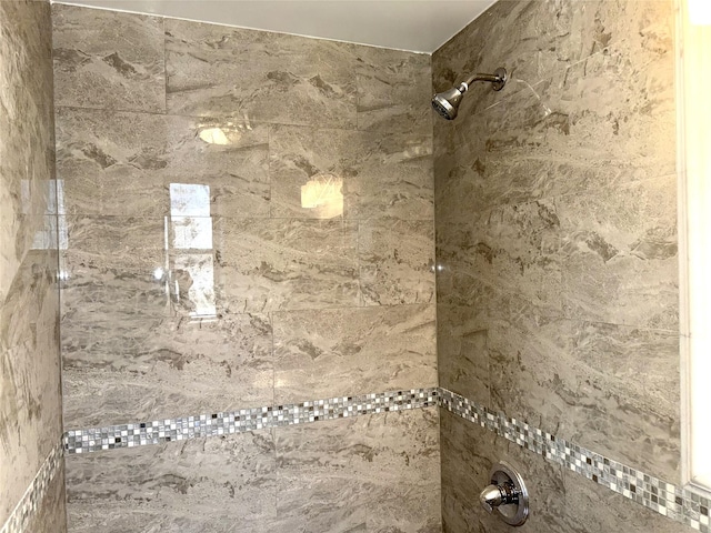 full bath featuring a tile shower