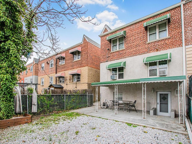 back of property featuring a patio area, stucco siding, and fence