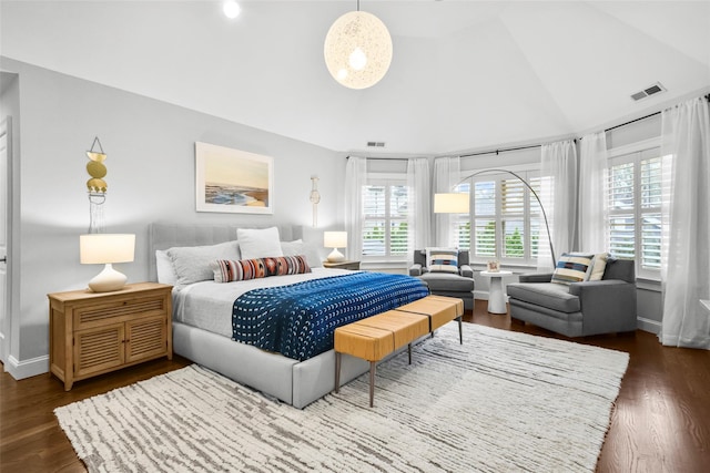 bedroom featuring vaulted ceiling, visible vents, baseboards, and dark wood-style floors
