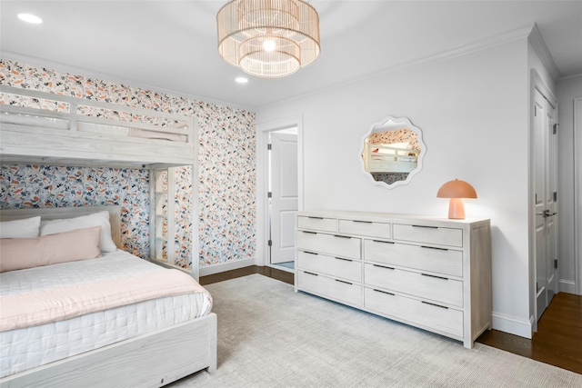 bedroom featuring light wood finished floors, a notable chandelier, crown molding, baseboards, and recessed lighting