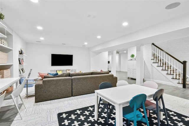 living room with stairs and recessed lighting