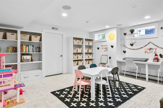 recreation room featuring visible vents, baseboard heating, and recessed lighting