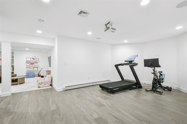 exercise area featuring a baseboard radiator, visible vents, recessed lighting, and wood finished floors