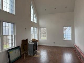 45 Manor Dr W, Poughkeepsie, NY 12603 - unfurnished living room with healthy amount of natural light, a high ceiling, and wood finished floors