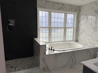 45 Manor Dr W, Poughkeepsie, NY 12603 - bathroom with a garden tub, plenty of natural light, and vanity
