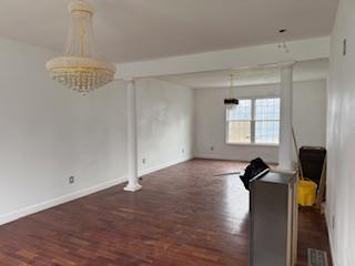 45 Manor Dr W, Poughkeepsie, NY 12603 - dining room with wood finished floors, baseboards, and a chandelier