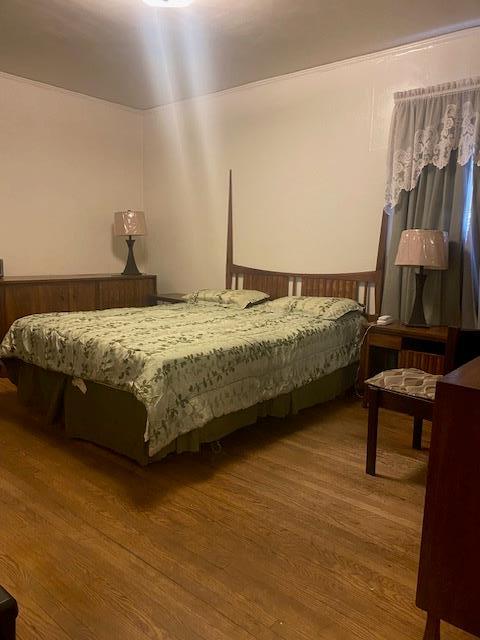 bedroom featuring wood finished floors
