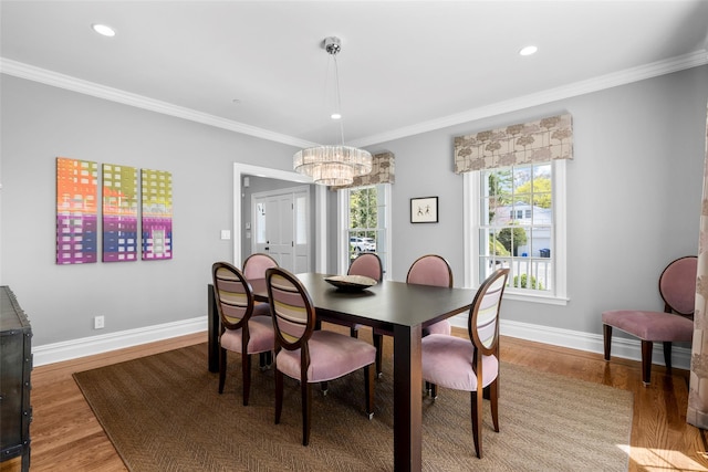 dining area with wood finished floors, baseboards, a chandelier, ornamental molding, and recessed lighting
