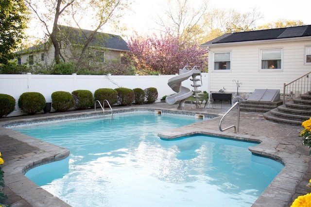 24 Akron Pl, Shoreham, NY 11786 - view of pool featuring a water slide, a fenced backyard, and a patio area