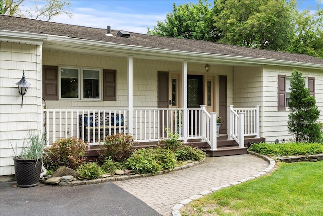 24 Akron Pl, Shoreham, NY 11786 - view of exterior entry with a porch and roof with shingles