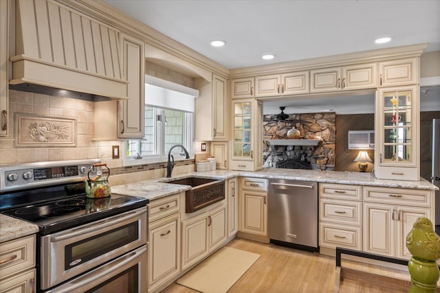 24 Akron Pl, Shoreham, NY 11786 - kitchen with cream cabinets, stainless steel appliances, a sink, and recessed lighting
