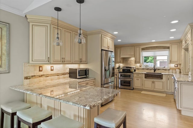 24 Akron Pl, Shoreham, NY 11786 - kitchen featuring stainless steel appliances, a sink, a peninsula, cream cabinetry, and recessed lighting