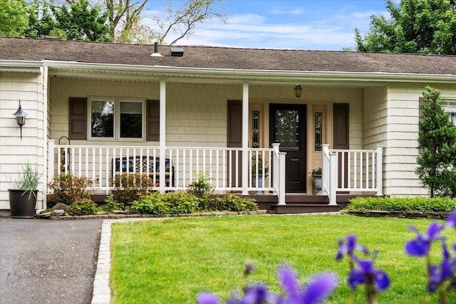 24 Akron Pl, Shoreham, NY 11786 - property entrance with a porch, a yard, and roof with shingles