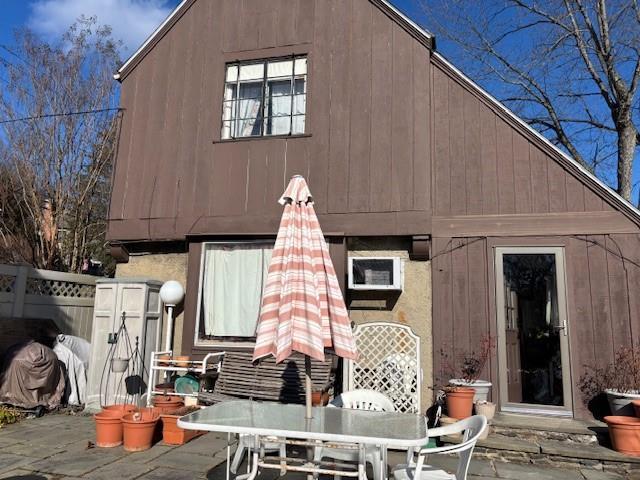 43 Garretson Rd, White Plains, NY 10604 - rear view of property featuring a patio, outdoor dining space, and fence