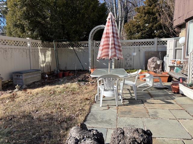 43 Garretson Rd, White Plains, NY 10604 - view of yard with a patio area, outdoor dining area, and a fenced backyard