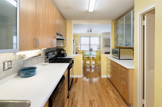 2500 Johnson Ave Unit 2Np, Bronx, NY 10463 - kitchen with stainless steel microwave, under cabinet range hood, light countertops, and black gas range oven