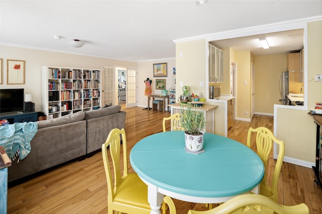 2500 Johnson Ave Unit 2Np, Bronx, NY 10463 - dining space with crown molding, baseboards, and light wood-type flooring