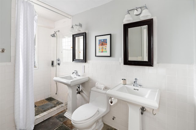2500 Johnson Ave Unit 2Np, Bronx, NY 10463 - bathroom featuring a stall shower, wainscoting, tile walls, and toilet