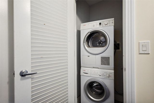 laundry area featuring laundry area and stacked washer and clothes dryer
