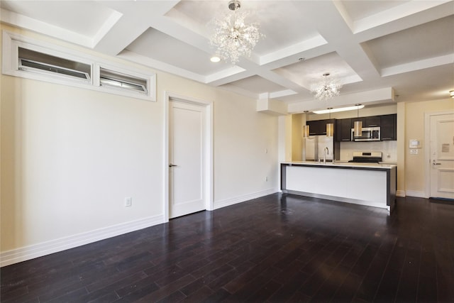 unfurnished living room featuring baseboards, coffered ceiling, dark wood-style flooring, and a notable chandelier