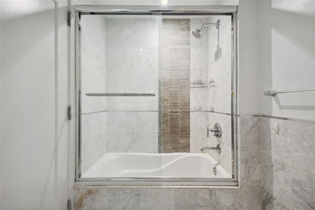full bathroom featuring bath / shower combo with glass door