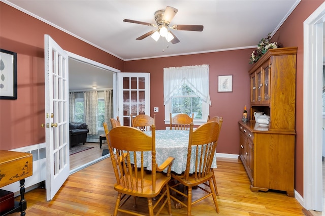 dining space with crown molding, ceiling fan, plenty of natural light, and light wood-style floors