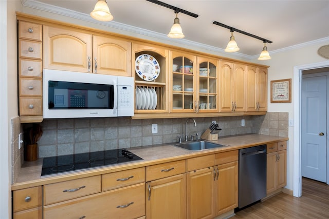 kitchen featuring crown molding, a sink, dishwasher, black electric cooktop, and white microwave