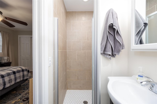 full bath featuring connected bathroom, a sink, a ceiling fan, ornamental molding, and a stall shower
