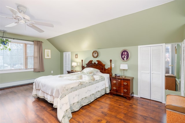 bedroom with a ceiling fan, dark wood-style floors, vaulted ceiling, and baseboard heating