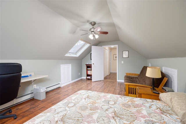 bedroom featuring vaulted ceiling with skylight, a baseboard radiator, wood finished floors, and ceiling fan