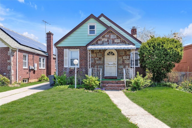 bungalow-style house featuring brick siding, fence, a chimney, and a front lawn