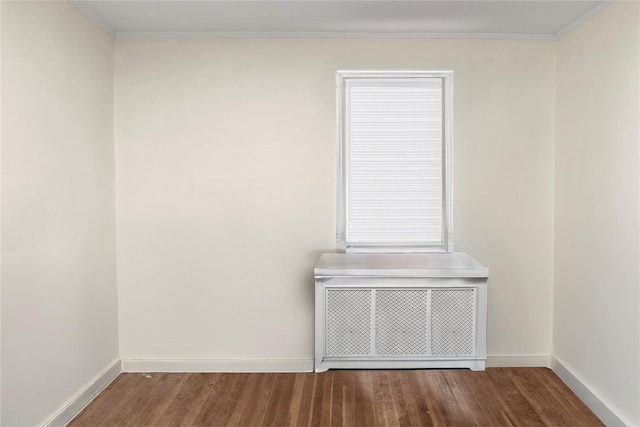 empty room with wood finished floors and baseboards