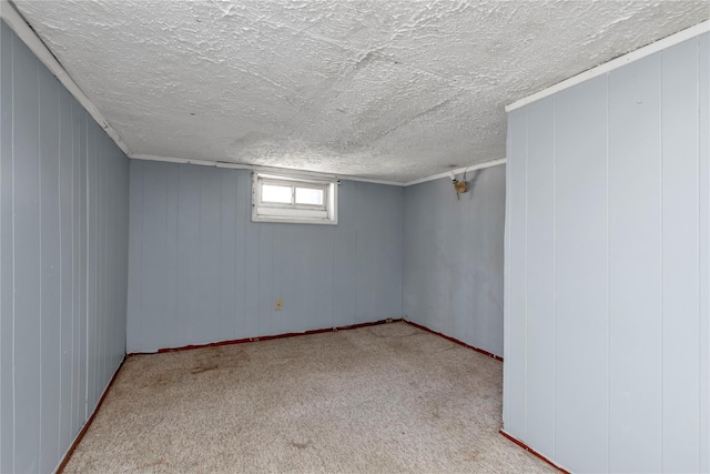 basement featuring a textured ceiling and carpet