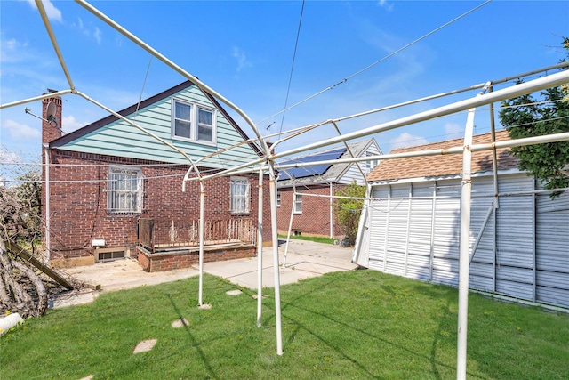 view of yard featuring fence, a patio, and an outdoor structure