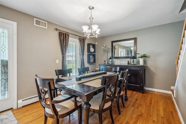 dining area with visible vents, light wood-type flooring, baseboards, a baseboard radiator, and a chandelier