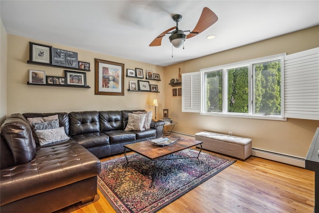 living area with a ceiling fan, a baseboard heating unit, recessed lighting, and wood finished floors